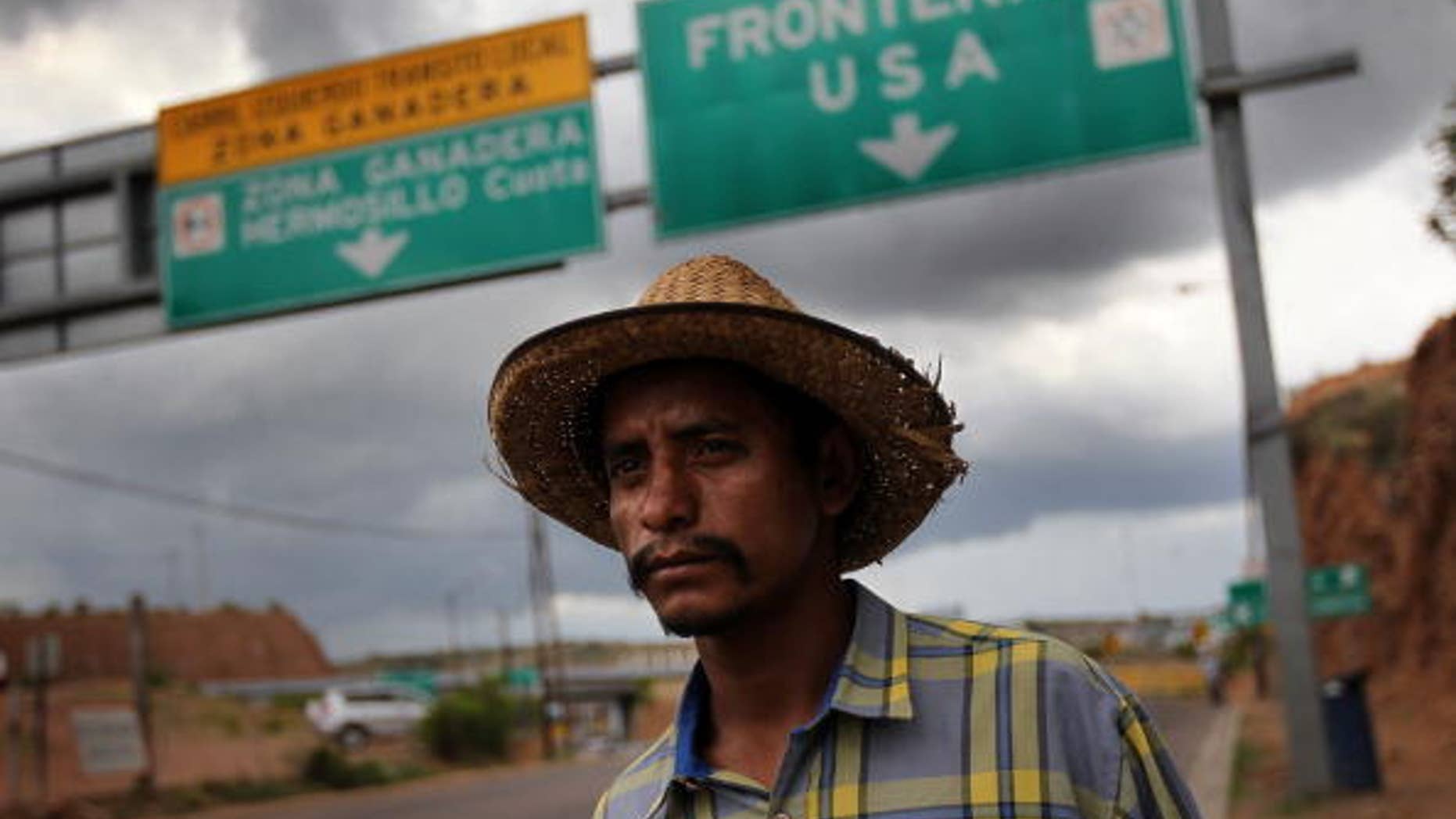 Jul 27: Mexican immigrant Luis Manuel, 29, walks along the U.S.- Mexico border after being deported from Arizona to Nogales, Mexico.