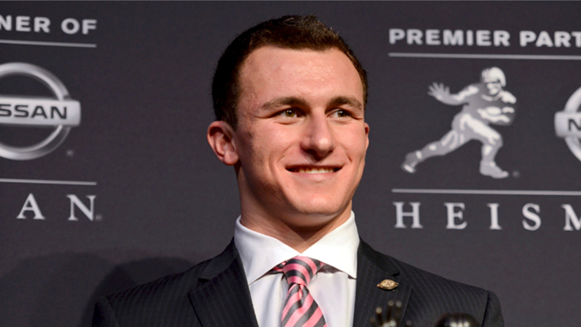 Dec. 8, 2012: Heisman Trophy winner Johnny Manziel of Texas A&M, poses with the Heisman Trophy following a news conference prior to the announcement of the winner in New York.
