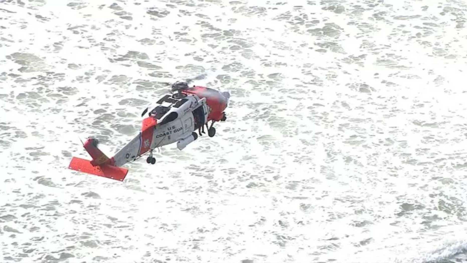 A U.S. Coast Guard helicopter crew searches Wednesday for a Fort Collins, Colo., teenager who reportedly fell into the surf off his boogie board off Rockaway Beach, Ore.