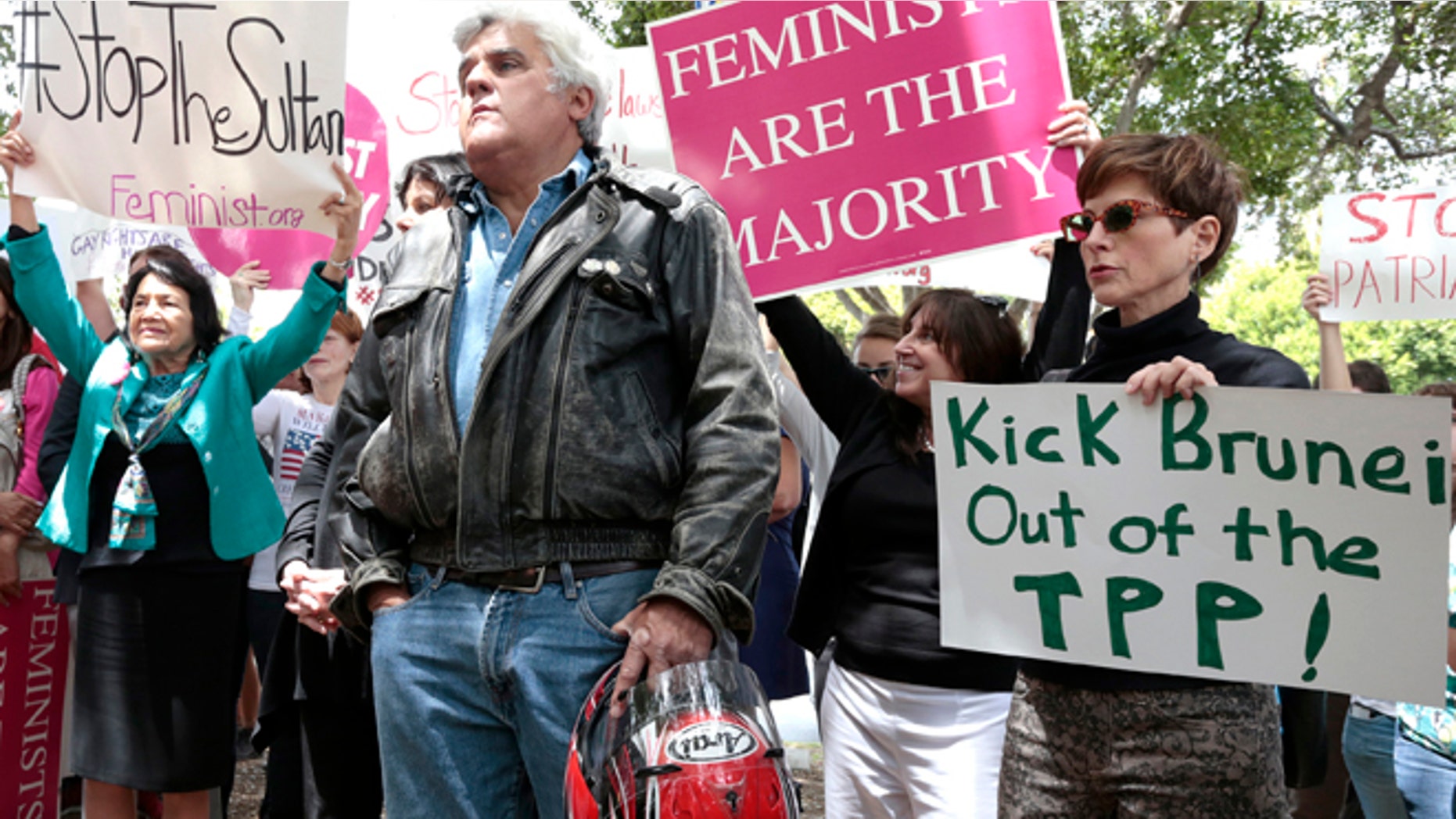 TV personality Jay Leno (C) attends a rally protesting against Brunei's new strict sharia law penal code outside the Beverly Hills Hotel, which is owned by the Sultan of Brunei, in Beverly Hills, California May 5, 2014. The sultanate of Brunei becomes the first East Asian country to introduce Islamic criminal law, the latest example of a deepening religious conservatism that has also taken root in parts of neighbouring Malaysia and Indonesia. REUTERS/Jonathan Alcorn (UNITED STATES - Tags: CIVIL UNREST RELIGION ENTERTAINMENT) - RTR3NWAD