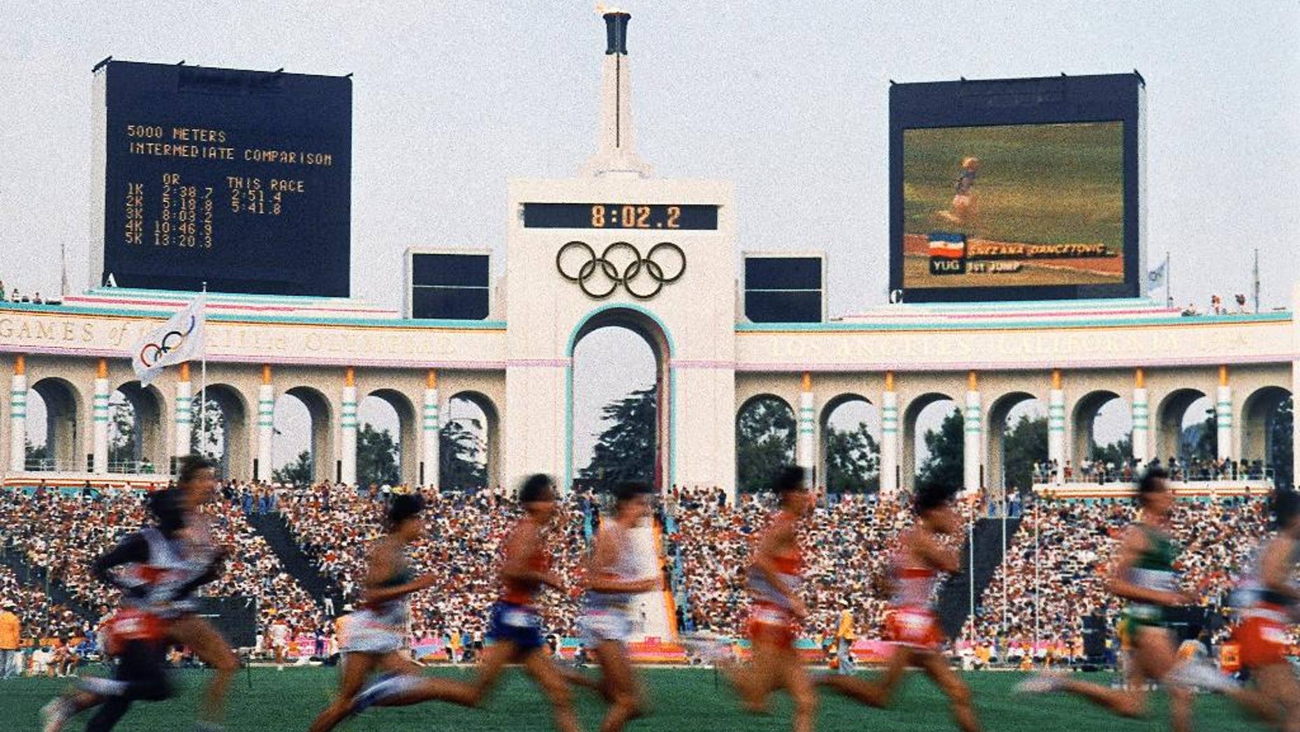 FILE - In this Aug. 1984 file photo, competitors run in the men's 5,000 meters at the Olympic Games in Los Angeles. (AP Photo/File)