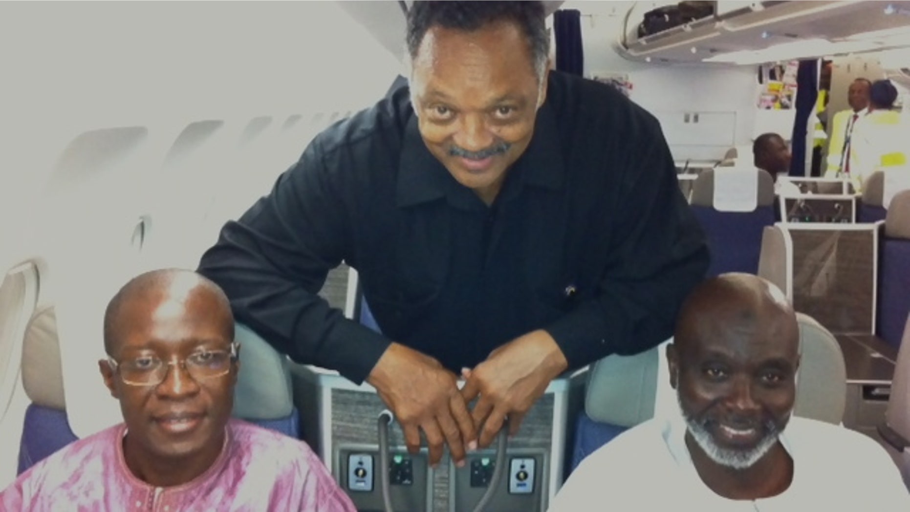 Sept. 18, 2012: The Rev. Jesse Jackson with Amadou Janneh and Tamsir Jasseh on the flight to the U.S.