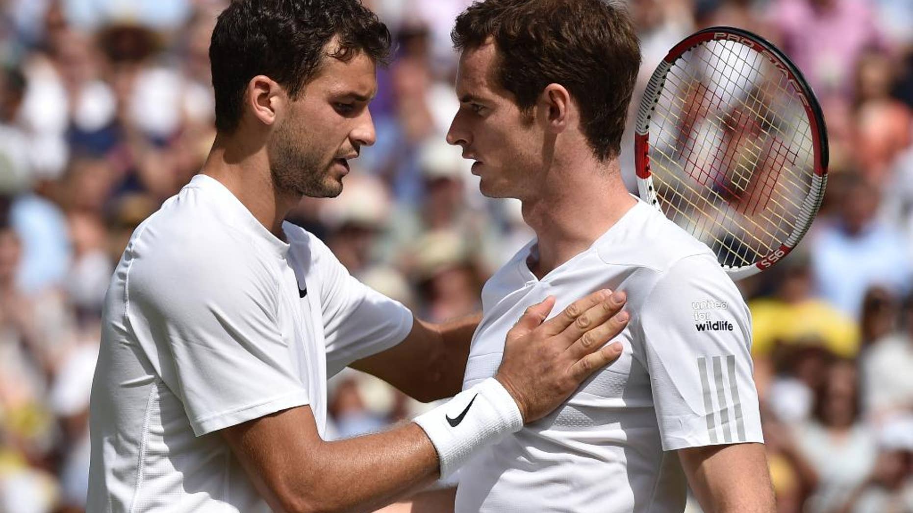 Grigor Dimitrov of Bulgaria, left, is congratulated by defending champion Andy Murray of Britain after winning their men's singles quarterfinal match at the All England Lawn Tennis Championships in Wimbledon, London, Wednesday July 2, 2014. (AP Photo/Toby Melville, Pool)