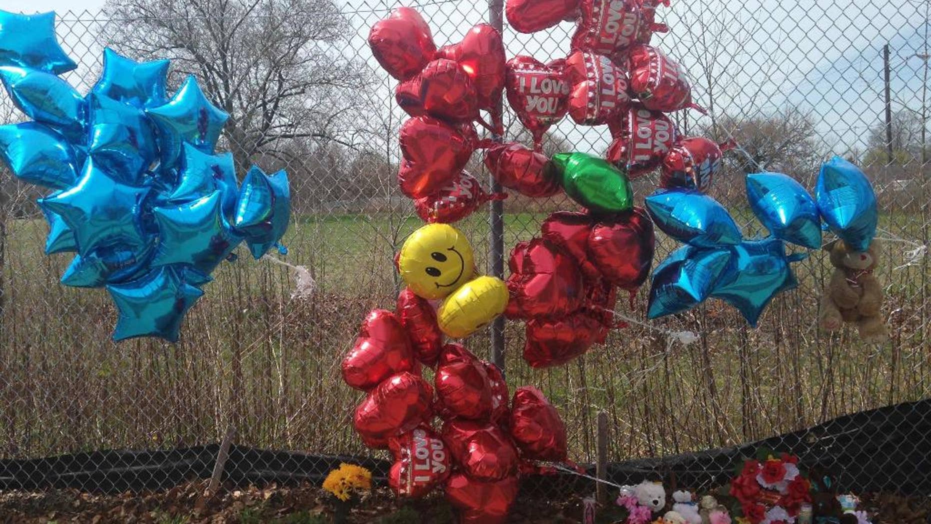 A makeshift memorial sits along a fence Monday, April 17, 2017, near where Robert Godwin Sr., was killed in Cleveland. Police said Steve Stephens killed Godwin on Sunday and posted the video on Facebook. (AP Photo/Mike Householder)