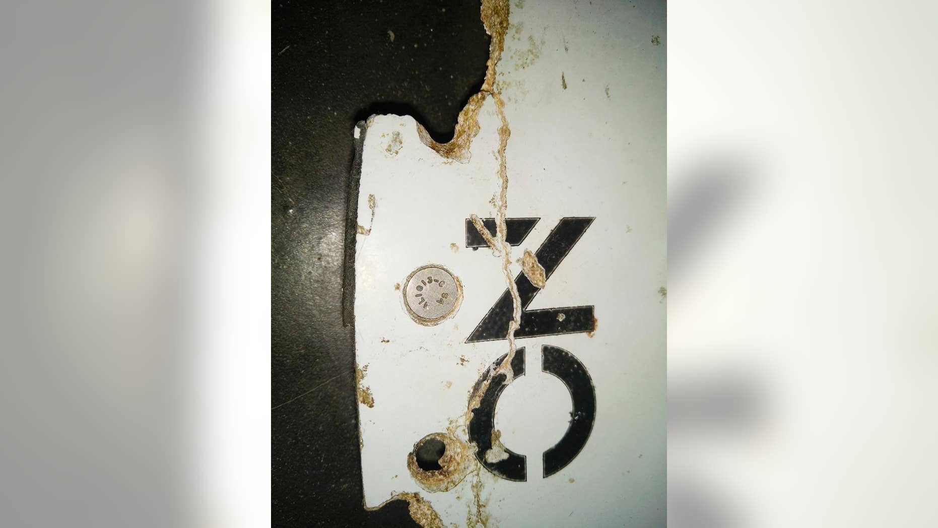 FILE - This Feb. 28, 2016 photo provided by Blaine Gibson and the Australian Transport Safety Bureau (ATSB) shows a piece of aircraft debris with the words "NO STEP" found washed up on a beach in Mozambique. On Sunday, April 3, 2016, Australian officials said a piece of debris found on the Indian Ocean island of Mauritius will be examined by investigators to see if it came from missing Malaysia Airlines Flight 370. The discovery comes less than two weeks after officials confirmed that two pieces of debris found along the coast of Mozambique were almost certainly from the aircraft that vanished on March 8, 2014, with 239 people on board during a flight from Kuala Lumpur to Beijing. (Blaine Gibson/ATSB via AP) MANDATORY CREDIT
