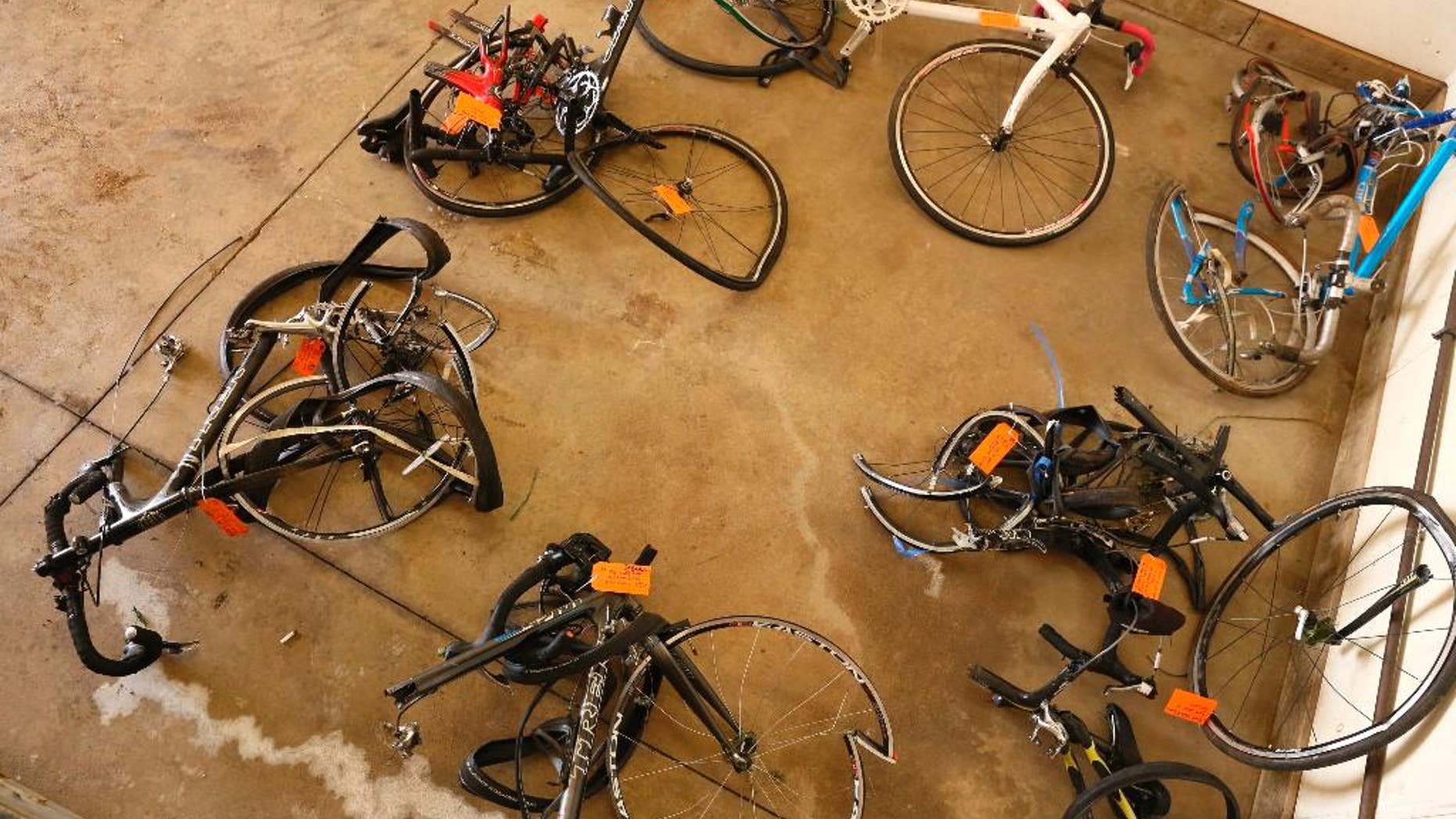 FILE- In this June 9, 2016 file photo, mangled bicycles are tagged as evidence at the Michigan State Police crime lab in Kalamazoo, Mich. The National Transportation Safety Board says better communication between police agencies might have prevented the deaths of five bicyclists last year in southwestern Michigan. A pickup truck plowed into cyclists on a rural road near Kalamazoo last June. The NTSB says 22 minutes passed between the first 911 call about an erratic driver and the crash. The board says Charles Pickett Jr. might have been stopped if dispatchers for three police agencies had shared more information. (Mark Bugnaski/Kalamazoo Gazette-MLive Media Group via AP)