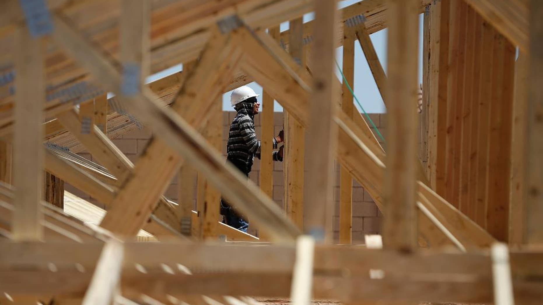 In this April 13, 2015, photo, a worker helps to frame a new home at a housing tract in Las Vegas. The Commerce Department reports on U.S. construction spending in March on Friday, May 1, 2015. (AP Photo/John Locher)