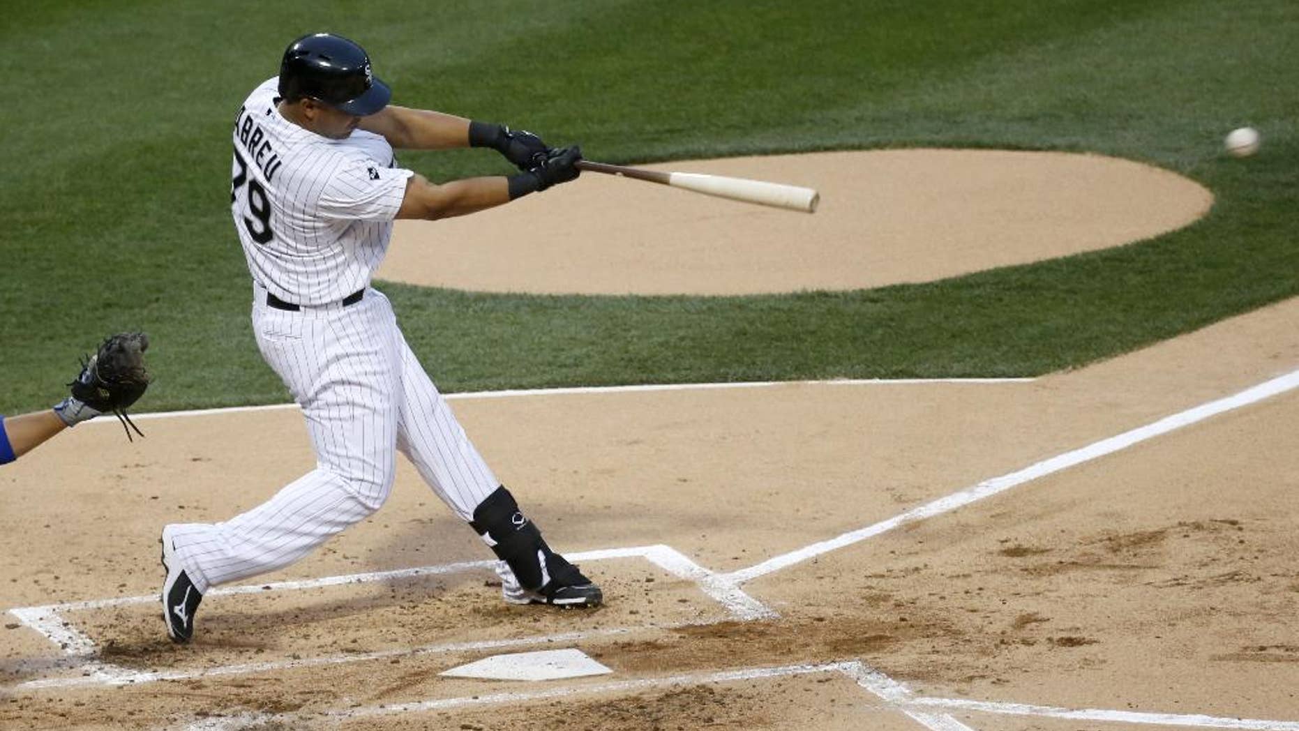 Chicago White Sox's Jose Abreu hits a single off Chicago Cubs starting pitcher Jake Arrieta during the first inning of an interleague baseball game Thursday, May 8, 2014, in Chicago. (AP Photo/Charles Rex Arbogast)