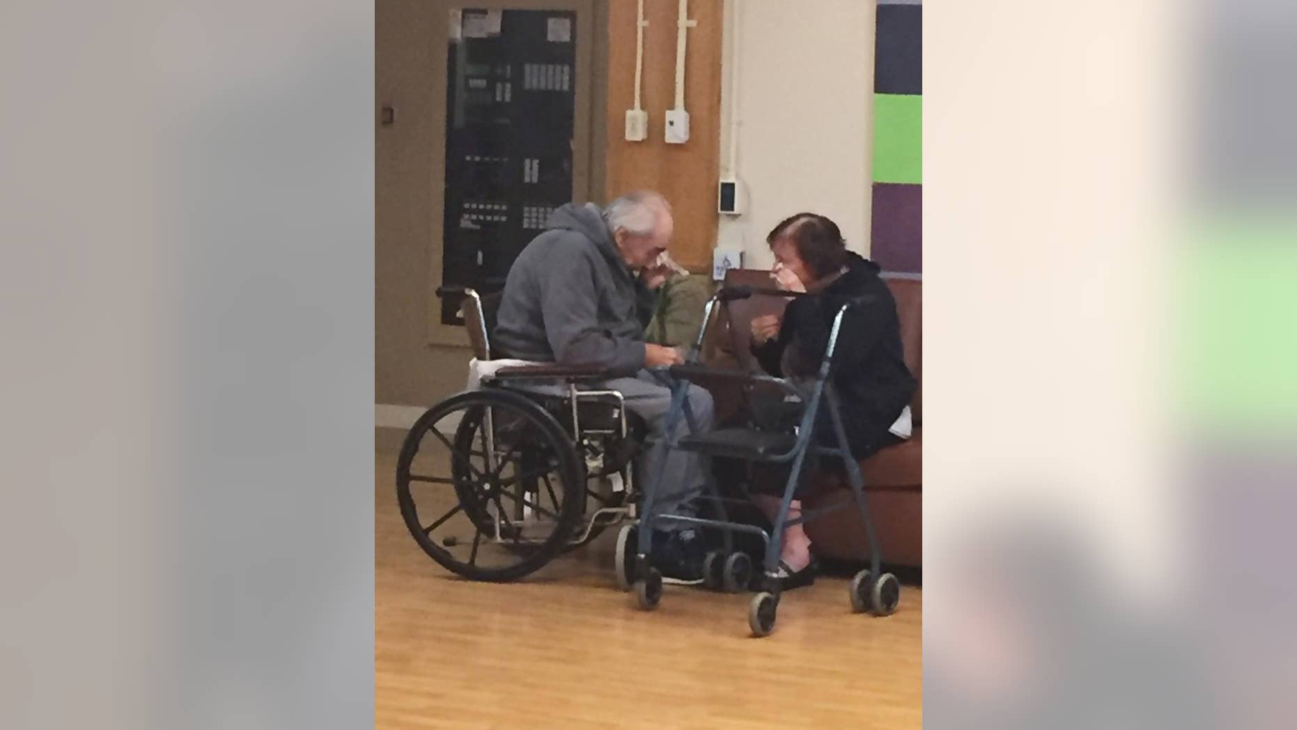 In this Monday, Aug. 22, 2016 photo provided by Ashley Bartyik, her grandparents Wolfram and Anita Gottschalk of Surrey, British Columbia, Canada, cry as they say goodbye near the end of a visit with each other in Wolfram's elderly care home in Surrey. The couple, who are in their 80s, were separated into two different care homes a half an hour apart after 62 years of marriage because no beds were available together. (Ashley Bartyik via AP)