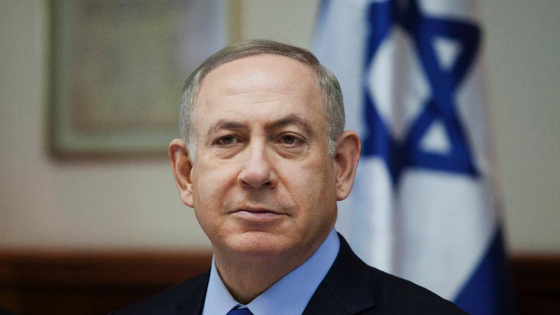 FILE -- In this Sunday, Dec. 25, 2016 file photo, Israeli Prime Minister Benjamin Netanyahu attends a weekly cabinet meeting in Jerusalem. On Wednesday, Jan. 5, 2017, Netanyahu called for a pardon for a soldier convicted of manslaughter in the shooting death of a badly wounded Palestinian assailant. With his comment, the prime minister has plunged into a raging political debate that has divided the country and put himself at odds with the military. Sgt. Elor Azaria was convicted on Wednesday of manslaughter in the fatal shooting of a Palestinian who lay on the ground incapacitated from shots sustained after he stabbed and wounded a soldier in the volatile West Bank city of Hebron. (Dan Balilty/Pool photo via AP, File)