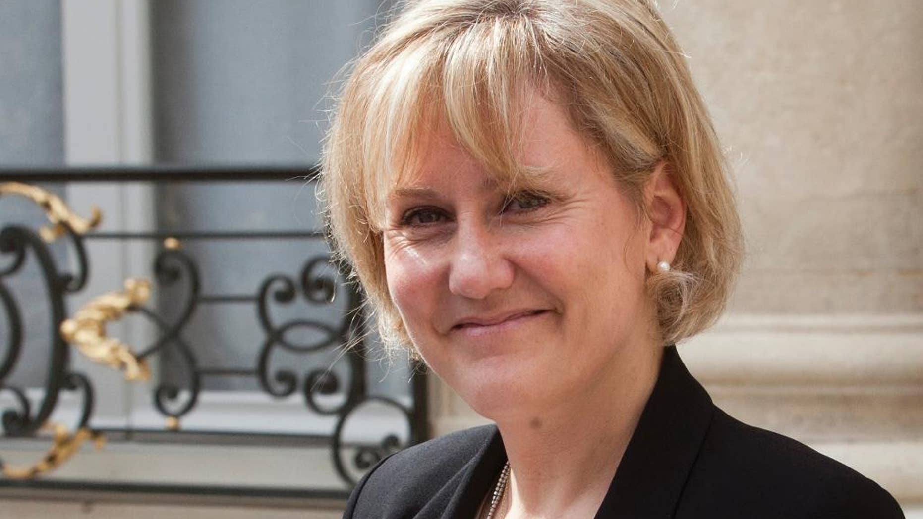 FILE - In this Wednesday, May 9, 2012 file photo, French Minister for apprenticeship and professional formation Nadine Morano smiles after French President Nicolas Sarkozy's last weekly cabinet meeting in the Elysee Palace, Paris. The party of former French President Nicolas Sarkozy has excluded one of its most high-profile figures from running in December regional elections after she said that France is a "country of the white race," a remark that caused a scandal reaching beyond the party. Nadine Morano, minister for professional training when Sarkozy was in office, was unanimously voted off a list in eastern France by the Republicans. Sarkozy had relied on Morano to stretch the reach of his conservative party to the far right. But her remark during a Sept. 26, 2015 talk show, repeated several times, caused an uproar. (AP Photo/Jacques Brinon, file)