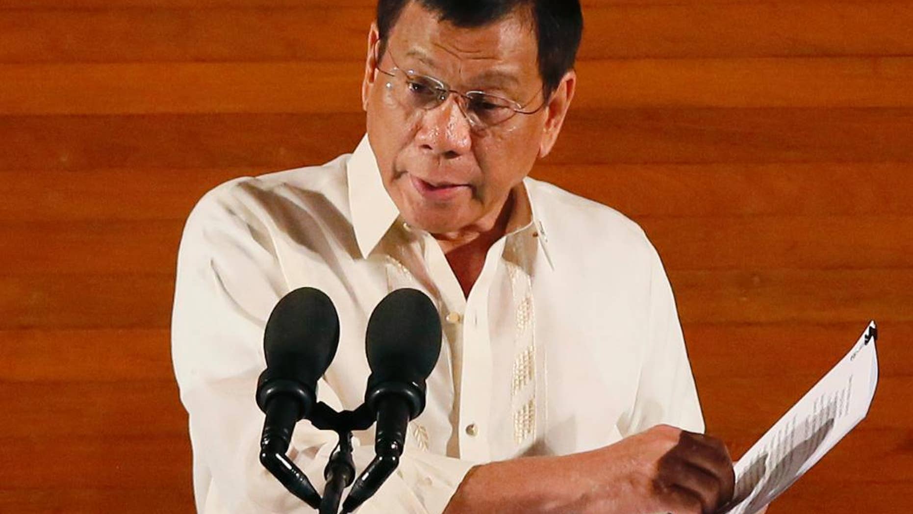 FILE - In this Monday, July 25, 2016 file photo, Philippine President Rodrigo Duterte delivers his first State of the Nation Address before the joint session of the 17th Congress in suburban Quezon city, northeast of Manila, Philippines. Duterte on Thursday, July 28, threatened to withdraw a ceasefire order he gave three days ago after suspected communist rebels killed a government militiaman and wounded four others in an attack. (AP Photo/Bullit Marquez, File)