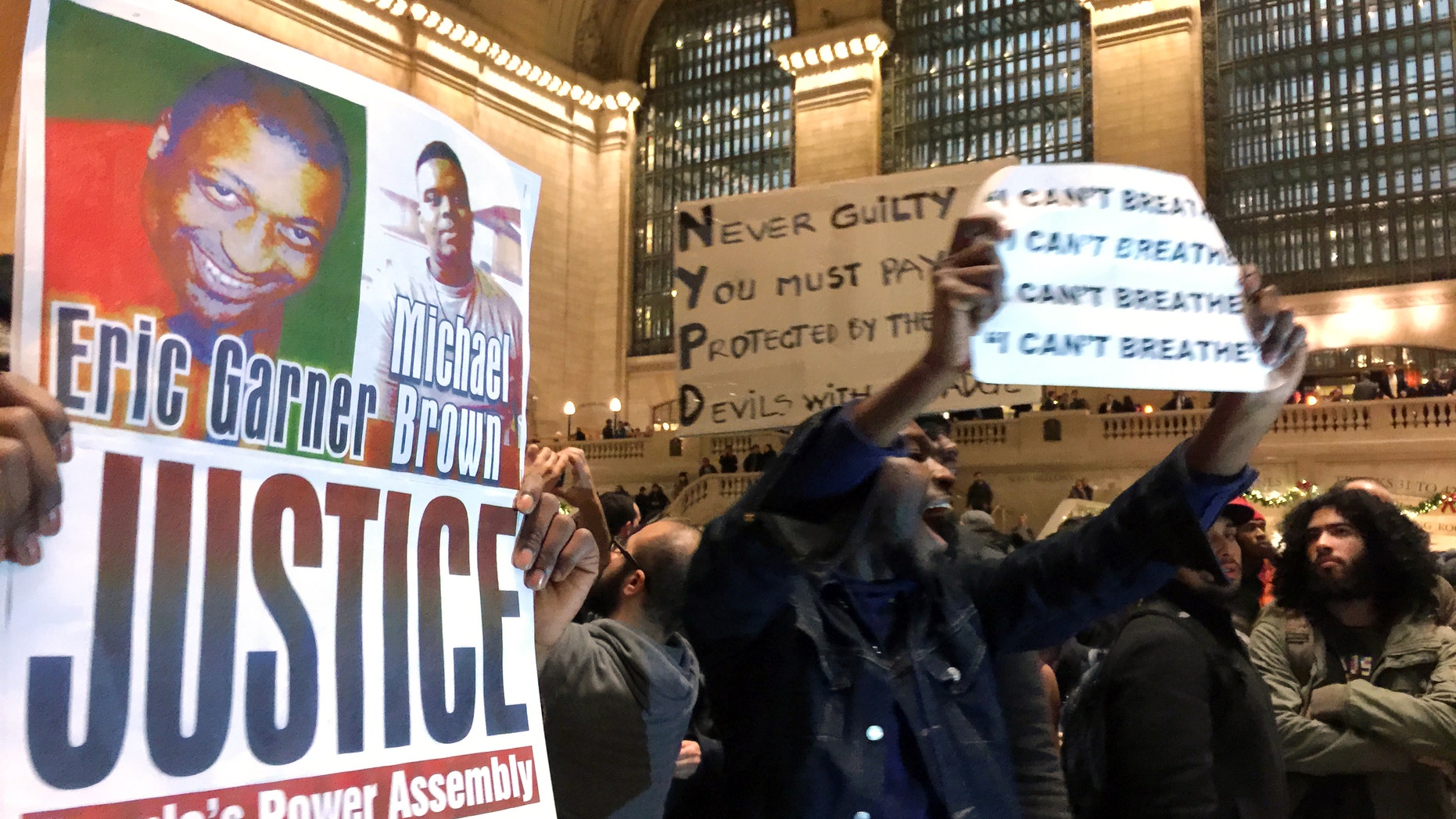 People protest in Grand Central Terminal on Wednesday, Dec. 3, 2014, in New York.