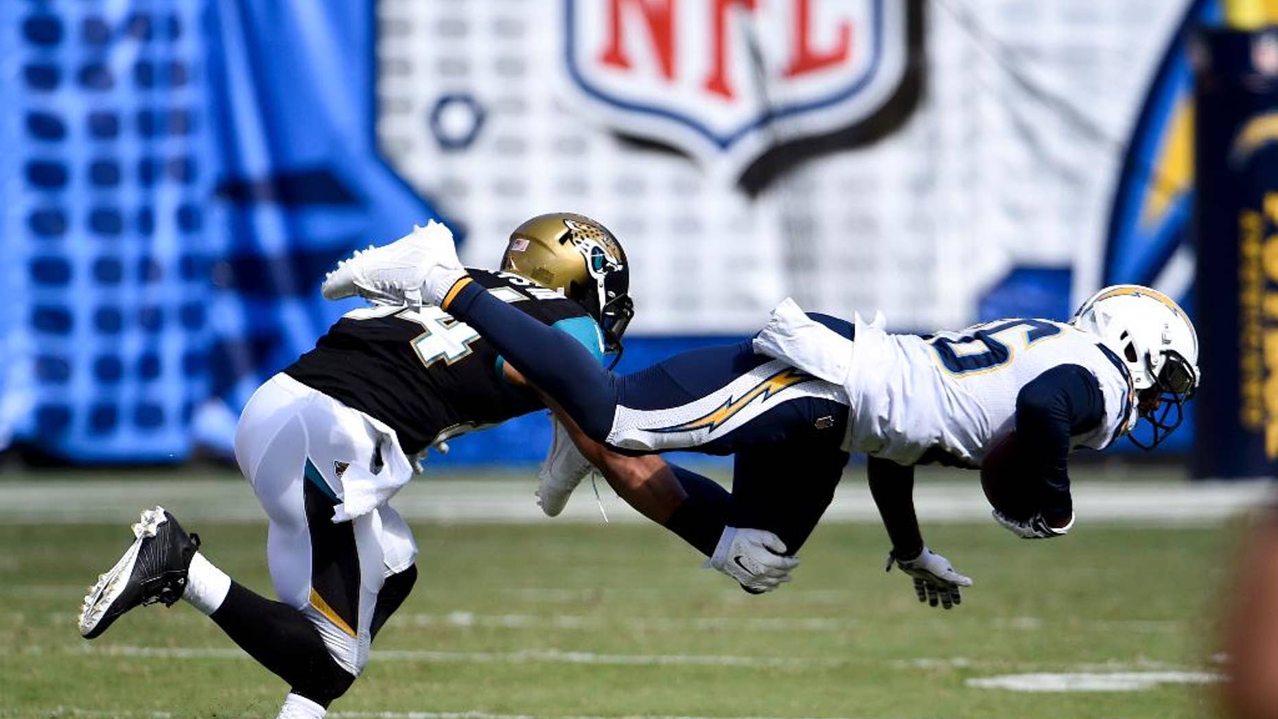 San Diego Chargers cornerback Brandon Flowers intercepts a pass in front of Jacksonville Jaguars wide receiver Cecil Shorts during the second half of an NFL football game Sunday, Sept. 28, 2014, in San Diego. (AP Photo/Denis Poroy)
