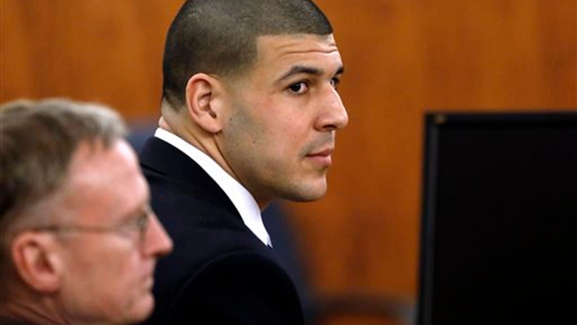 Aaron Hernandez with defense attorney Charles Rankin before the jury began deliberations on April 9, 2015.