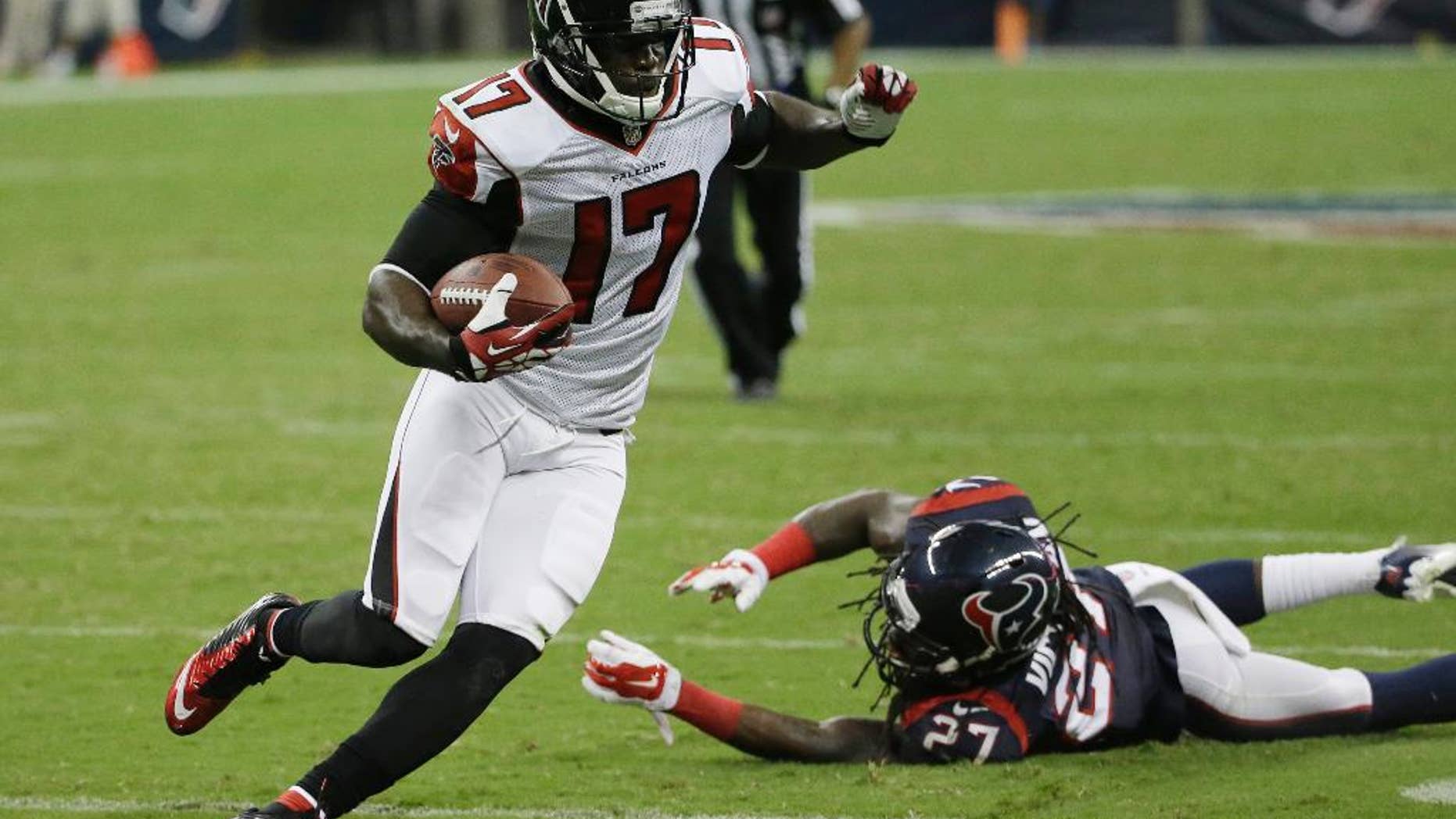 Atlanta Falcons' Devin Hester (17) evades Houston Texans' Josh Victorian (27) as he runs for a touchdown during the second quarter of an NFL preseason football game Saturday, Aug. 16, 2014, in Houston. (AP Photo/David J. Phillip)