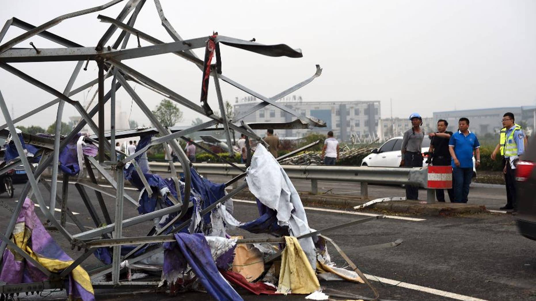 The remains of a steel tower are photographed in Funing County, in east China's Jiangsu Province, on Thursday, June 23, 2016, after a tornado hit the area. A powerful tornado on Thursday killed a number of people and destroyed a large numbers of buildings in the eastern Chinese province of Jiangsu, state media reported. (Xinhua via AP) NO SALES