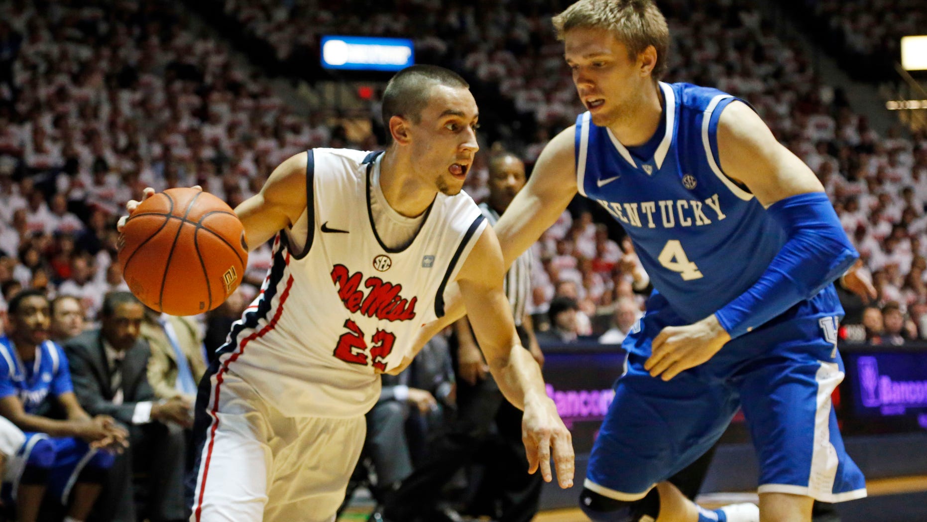 Mississippi guard Marshall Henderson (22) drives up court past Kentucky guard Jon Hood (4) in the first half of their NCAA college basketball game, Tuesday, Jan. 29, 2013 in Oxford, Miss. Kentucky won 87-74. (AP Photo/Rogelio V. Solis)