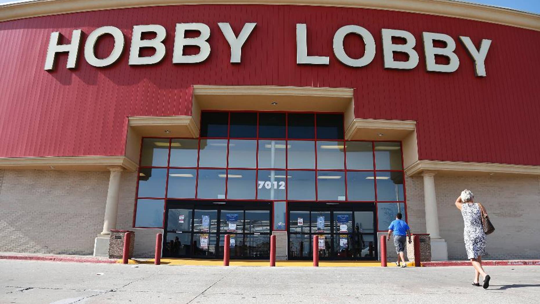 Customers walk to a Hobby Lobby store in Oklahoma City, Monday, June 30, 2014. The Supreme Court ruled Monday that employers can hold religious objections that allow them to opt out of the new health law requirement that they cover contraceptives for women. The Hobby Lobby chain of arts-and-crafts stores is by far the largest employer of any company that has gone to court to fight the birth control provision. (AP Photo/Sue Ogrocki)
