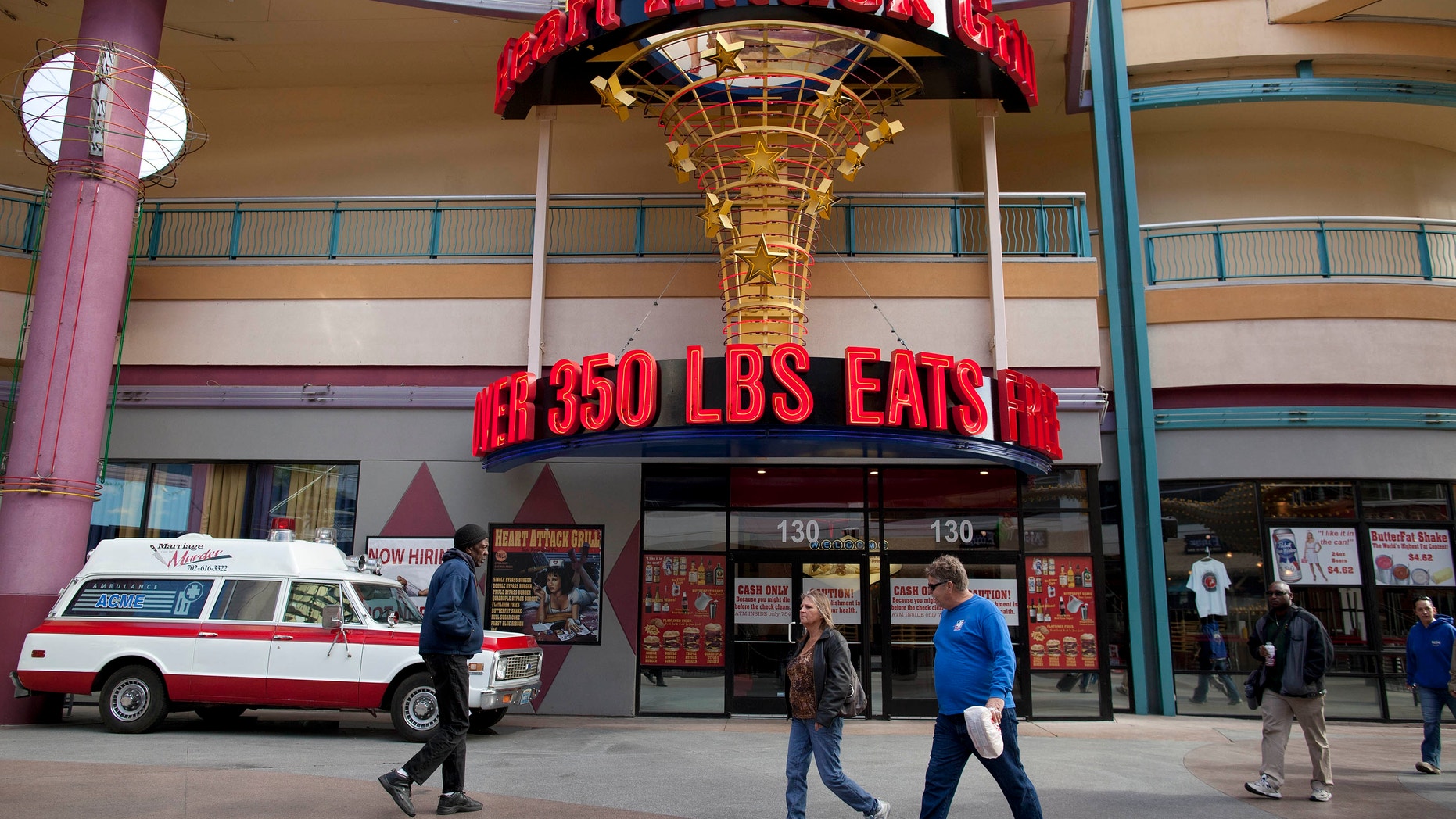 Feb. 15, 2012: Pedestrians pass by the Heart Attack Grill on Fremont Street in Las Vegas.