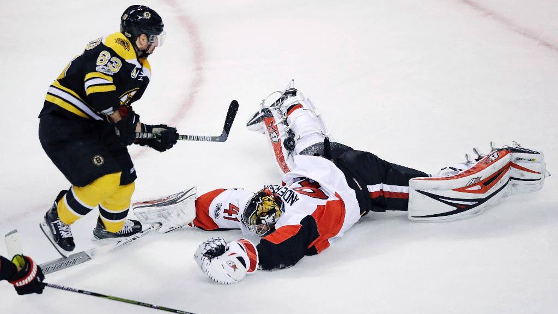 Ottawa Senators goalie Craig Anderson (41) makes a diving save on a shot by Boston Bruins left wing Brad Marchand (63) during the first period of Game 4 of a first-round NHL hockey playoff series in Boston, Wednesday, April 19, 2017. (AP Photo/Charles Krupa)