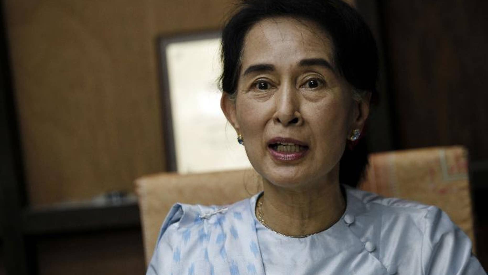 Myanmar opposition leader Aung San Suu Kyi addresses reporters at the National League for Democracy (NLD) headquarters in Yangon on September 27, 2013