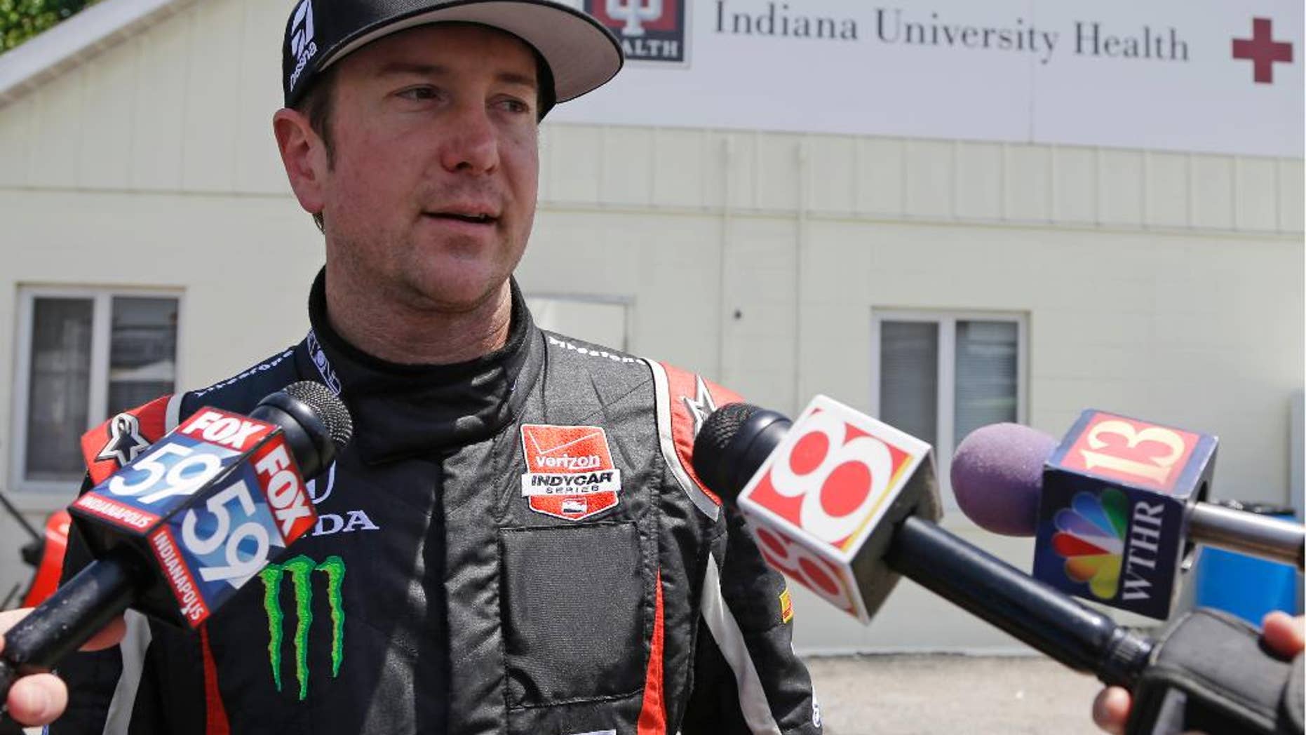 Kurt Busch is interviewed as he leaves the track medical center after he crashed in the second turn during practice for the Indianapolis 500 IndyCar auto race at the Indianapolis Motor Speedway in Indianapolis, Monday, May 19, 2014. (AP Photo/Michael Conroy)