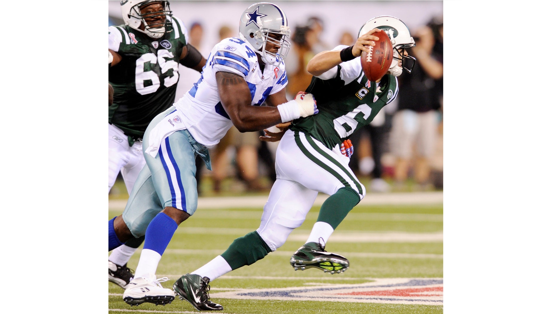 Sept. 11: Dallas Cowboys outside linebacker DeMarcus Ware (94) stops New York Jets quarterback Mark Sanchez (6) during the first half of an NFL football game. Sanchez was knocked around a bit in the win — he was sacked four times and took a number of other hard hits.