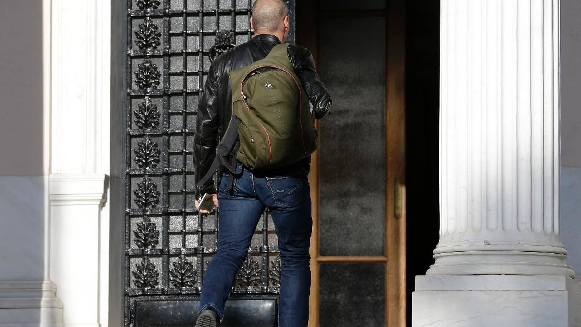 Greece's Finance Minister Yanis Varoufakis arrives for a ministerial meeting at Maximos Mansion in Athens, Wednesday, May 13, 2015. Greece's prime minister Alexis Tsipras was holding his second ministerial meeting in as many days Wednesday, when official data confirmed the cash-strapped country is back in recession amid concern over much-delayed bailout talks with creditors. (AP Photo/Thanassis Stavrakis)
