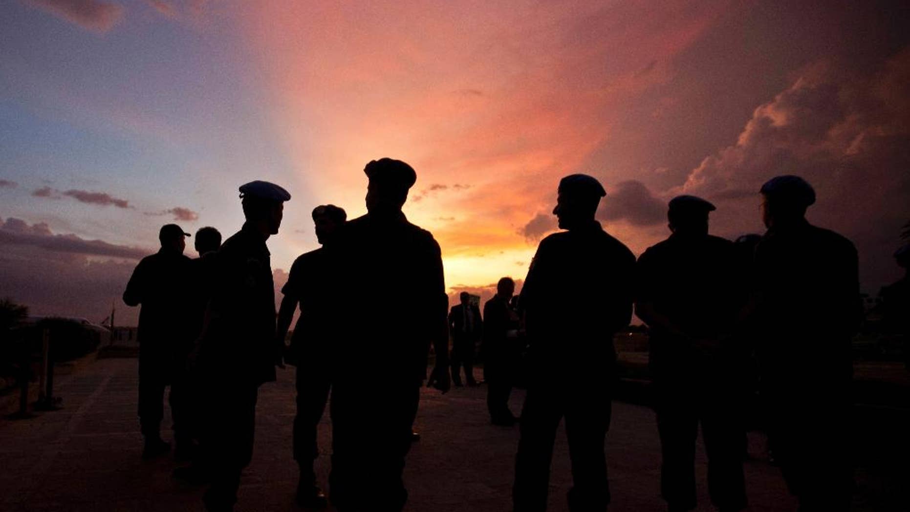 FILE - This Monday, July 11, 2011 file photo shows silhouettes of U.N. peacekeepers from Brazil at the airport in Port-au-Prince, Haiti. According to an AP investigation, some 150 allegations of abuse and exploitation were reported in Haiti between 2004 and 2016. The allegations involved U.N. peacekeepers and other personnel. Alleged victimizers came from Bangladesh, Brazil, Jordan, Nigeria, Pakistan, Uruguay and Sri Lanka, according to U.N. data and interviews. More countries may have been involved, but the United Nations only started disclosing alleged perpetrators’ nationalities after 2015. (AP Photo/Eduardo Verdugo)