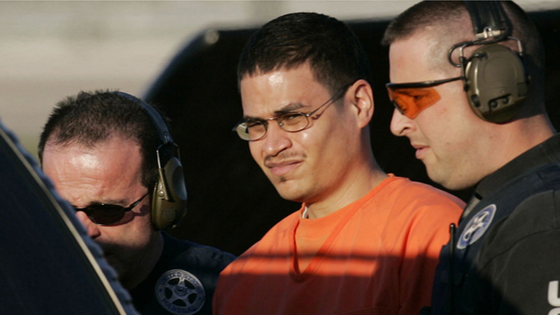Jan. 5, 2006: Jose Padilla, center, is escorted to a waiting police vehicle by federal marshals near downtown Miami.