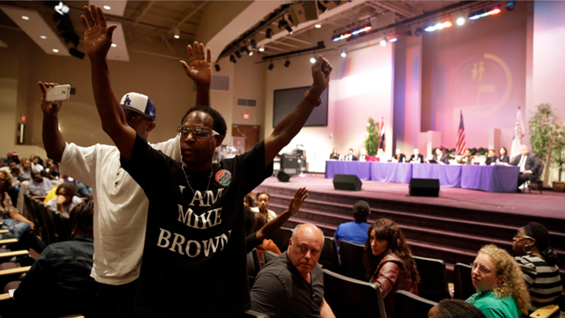 September 9, 2014: Maurice Brown raises his arms during a public comments portion of a meeting of the Ferguson City Council.