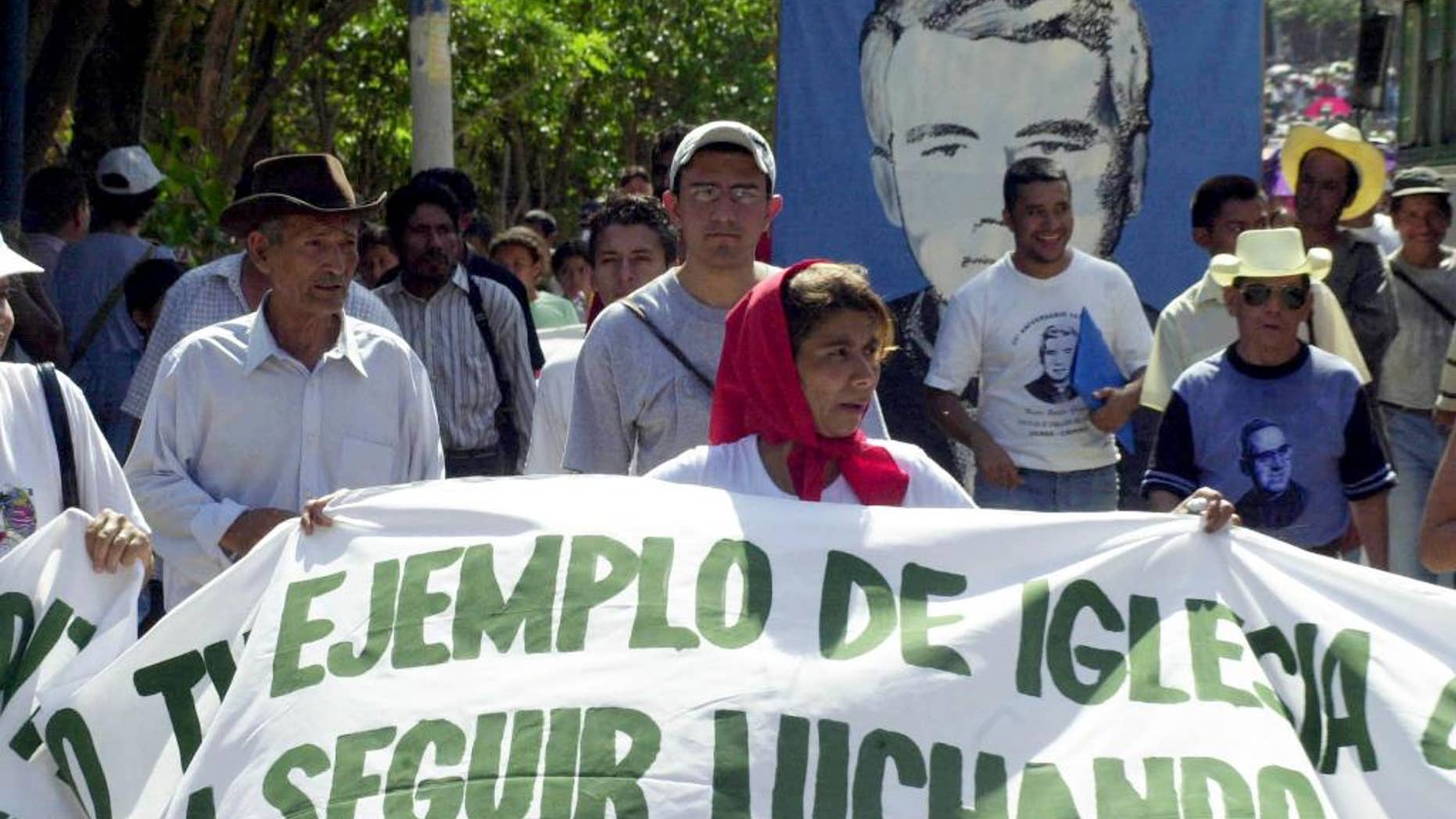 FILE - In this March 12, 2005, file photo, worshipers participate in a march to commemorate the anniversary of the death of Father Rutilio Grande, in Agulares, El Salvador. Grande was assassinated in 1977 by death squads during the civil war. The Catholic Church of El Salvador announced Wednesday, March 11, 2015, that they are preparing the process for the beatification of father Grande. (AP Photo/Edgar Romero, File)