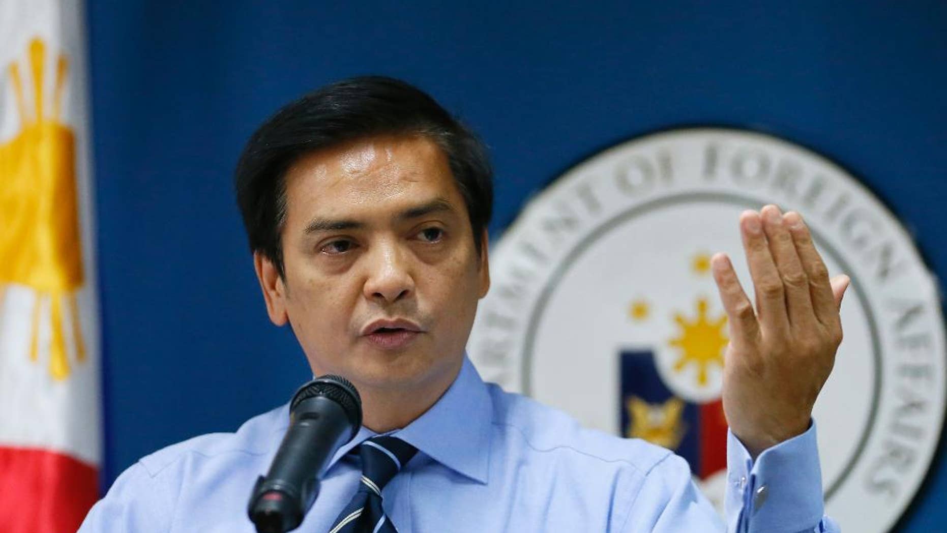 Charles Jose, assistant secretary and spokesman of the Department of Foreign Affairs, gestures during a news conference on Wednesday's killing of a couple of Chinese diplomats and the wounding of a consul-general by a fellow Chinese in Cebu city, central Philippines, at suburban Pasay city, south of Manila, Thursday, Oct. 22, 2015. Jose said, the suspect, who is the spouse of a Chinese diplomat, claimed diplomatic immunity and a team of Chinese officials will arrive to take custody of the couple for prosecution in China. (AP Photo/Bullit Marquez)