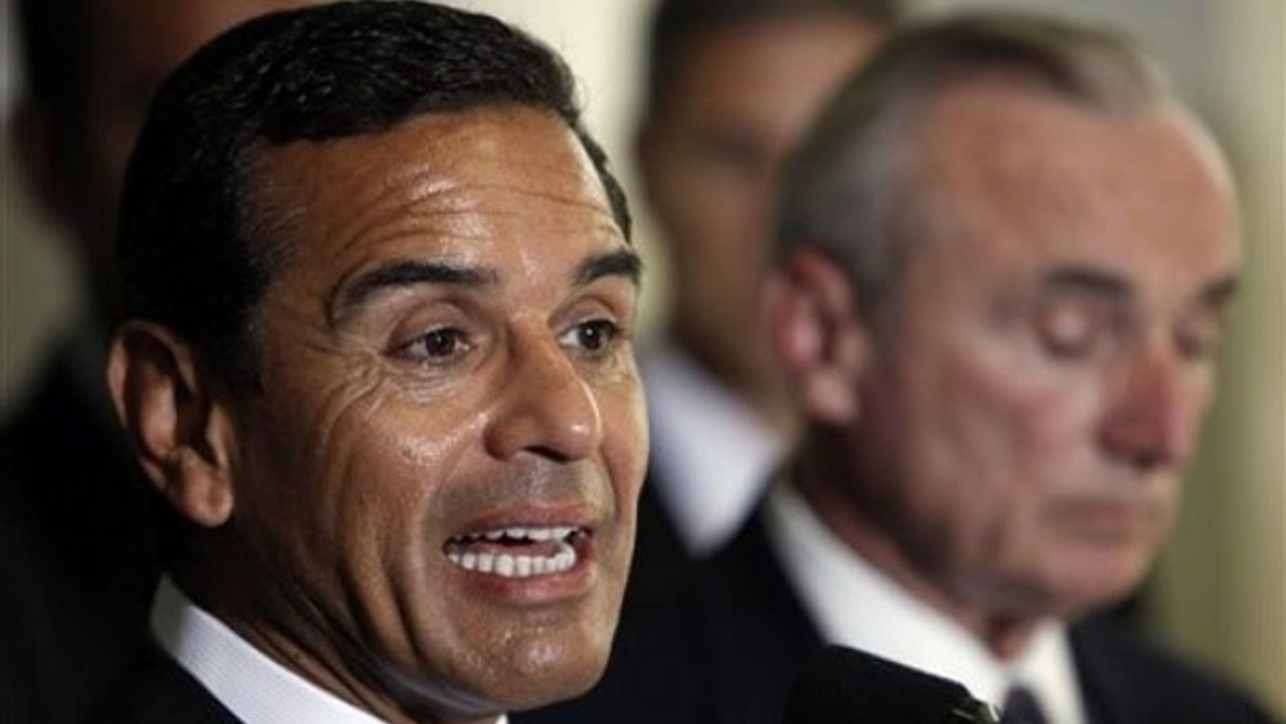 Los Angeles Mayor Antonio Villaraigosa, left, and police Chief William Bratton, unveil a multi-agency crackdown to curb an upsurge of gang violence in central and South Los Angeles, during a news conference at the LAPD's 77th Street Station on Tuesday, Aug. 25, 2009 in Los Angeles. The initiative will rely on the resources of the Los Angeles Police Department, the FBI, the Bureau of Alcohol, Tobacco, Firearms; the U.S. Marshals Service, and the California Highway Patrol. (AP Photo/Damian Dovarganes)