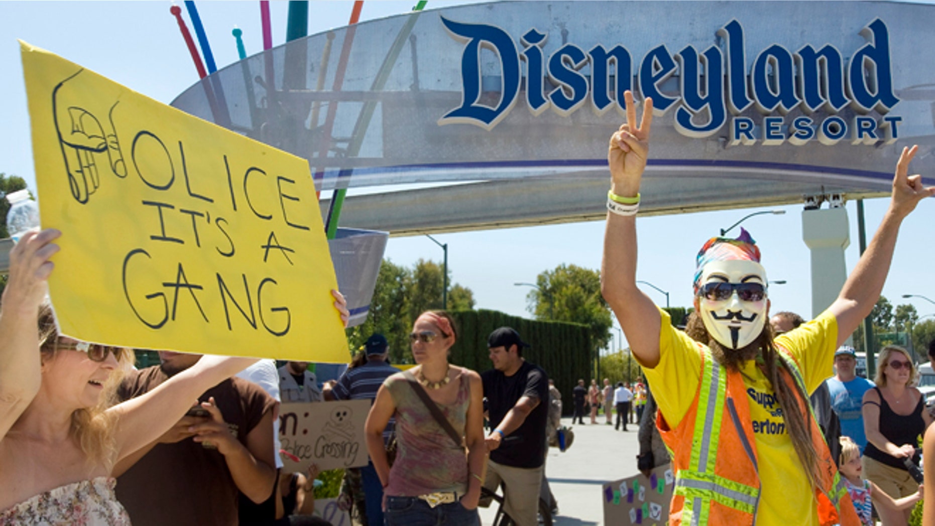 FILE - In this Aug. 5, 2012 file photo, protesters rally outside Disneyland in Anaheim, Calif., protesting what they say is excessive police force used by Anaheim police. Ferguson, Mo., has become an emblem of the tensions between minorities and police departments nationwide since Darren Wilson, a white officer, shot and killed Michael Brown, an unarmed black teenager, last summer. A U.S. Justice Department report released the first week of March, 2015, cleared Wilson of criminal wrongdoing. Though the study centered on Ferguson, its findings have resonated nationwide as residents in some communities across the country say they feel they face the same struggles with their police departments and city leadership. (AP Photo/The Orange County Register, Mindy Schauer, File)