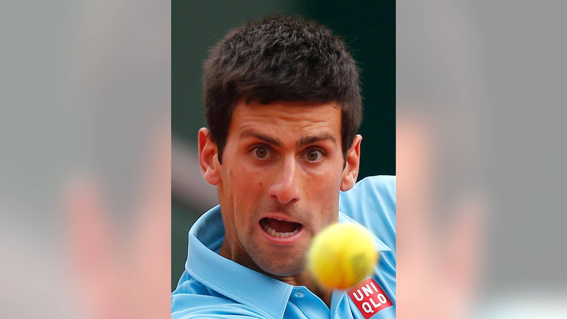 Serbia's Novak Djokovic eyes the ball as he plays France's Jo-Wilfried Tsonga during their fourth round match of the French Open tennis tournament at the Roland Garros stadium, in Paris, France, Sunday, June 1, 2014. (AP Photo/David Vincent)