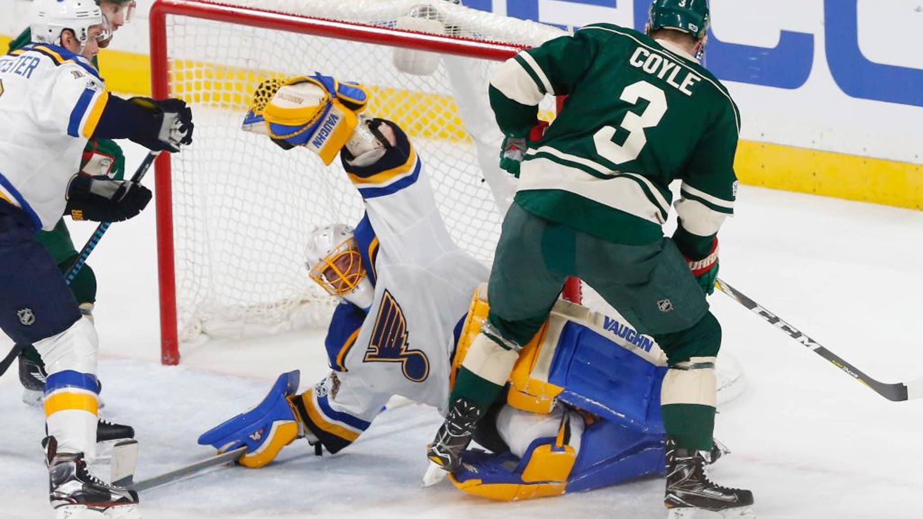 St. Louis Blues goalie Jake Allen stops a shot by Minnesota Wild's Charlie Coyle, right, during the second period of Game 1 of an NHL hockey first-round playoff series Wednesday, April 12, 2017, in St. Paul, Minn. (AP Photo/Jim Mone)