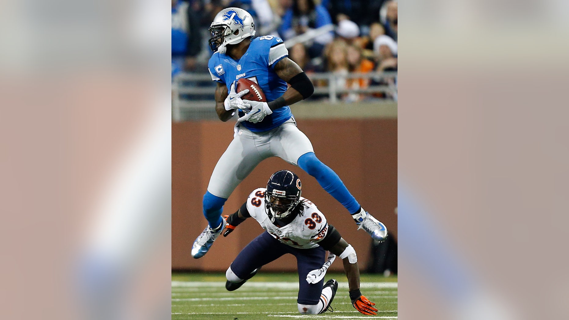 Detroit Lions wide receiver Calvin Johnson (81) gains 18-yards on a pass reception under pressure from Chicago Bears cornerback Charles Tillman (33) during the third quarter of an NFL football game at Ford Field in Detroit, Sunday, Dec. 30, 2012. (AP Photo/Rick Osentoski)