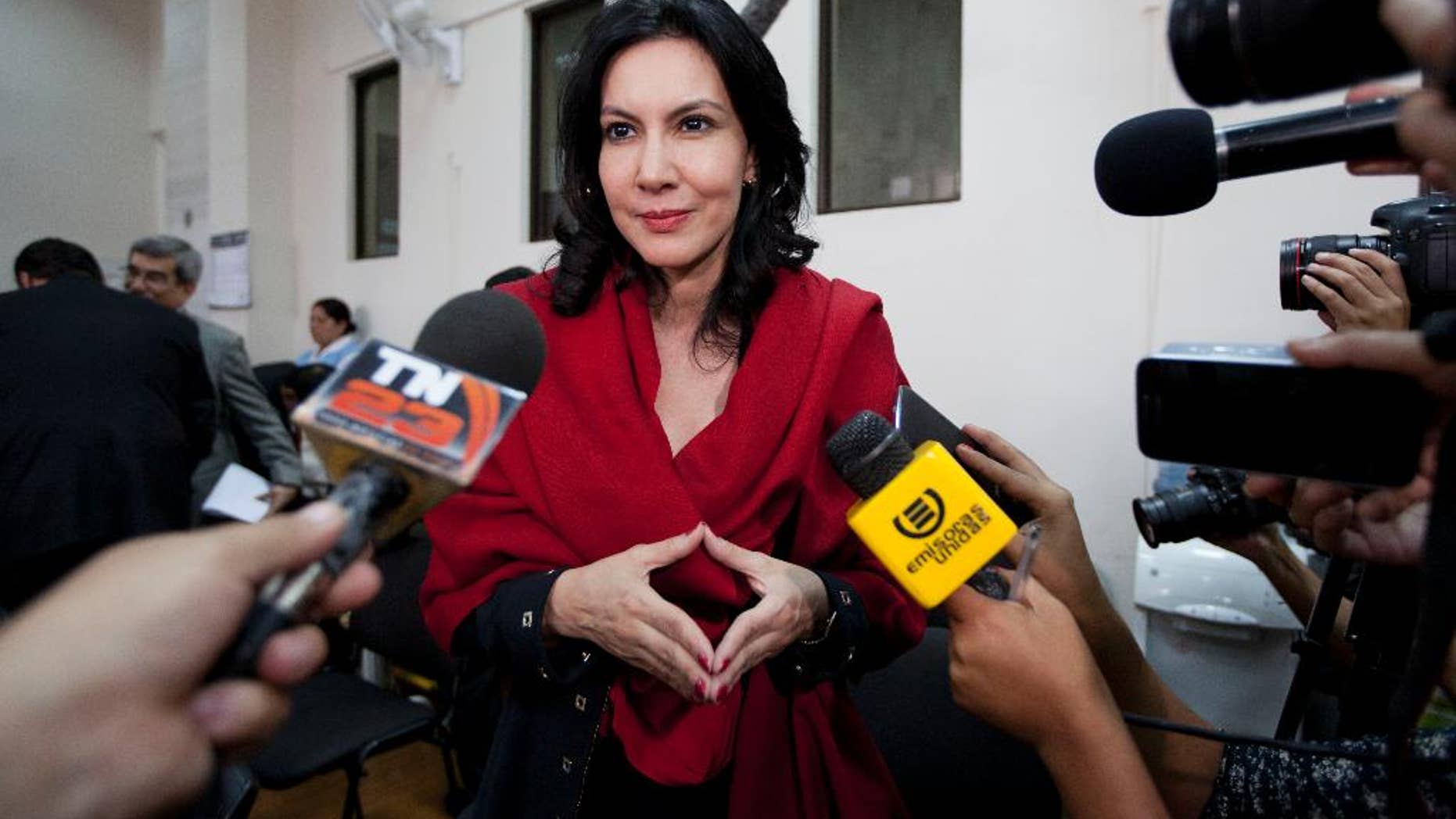 In this Jan. 5, 2015 photo, Zury Rios Sosa, the daughter of Guatemala's former dictator Efrain Rios Montt, talks with reporters as she accompanies her father to court where he faces charges of genocide and crimes against humanity, in Guatemala City. Zury Rios Sosa, a three-time member of congress, announced Thursday, April 16, 2015 that she would accept the nomination of the Christian conservative Vision with Values party to run for president in general elections later this year. (AP Photo/Moises Castillo)
