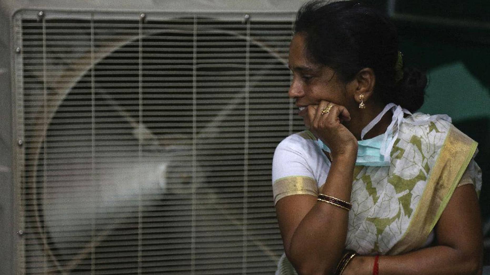 FILE - In this May 31, 2015 file photo, a woman cools herself on a hot summer day in Hyderabad, in the southern Indian state of Telangana. The U.N. weather agency said on Monday, Nov. 14, 2016, that 2016 is set to break the record for the hottest year since measurements began in the 19th century. (AP Photo/Mahesh Kumar A., File)