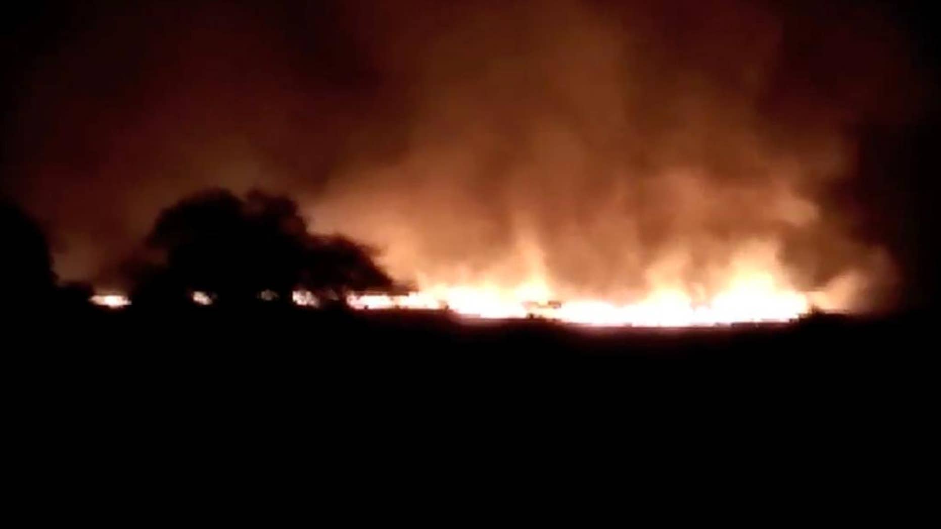 In this image made from video of K.K.Productions, a huge fire is seen at the Pulgaon ammunition depot in Pulgaon in the Indian state of Maharastra, Tuesday, May 31, 2016. A fire broke out at a major ammunitions depot in western India early Tuesday, causing fatalities, officials said. (K.K. Productions via AP) NO SALES