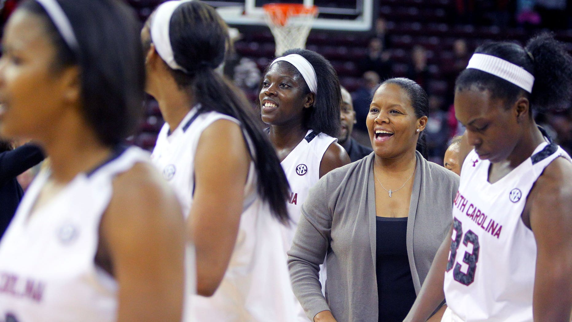 In this Nov. 8, 2013 photo, University of South Carolina assistant coach Nikki McCray, second from right, celebrates with the team after defeating Charleston Southern in Columbia, S.C. McCray says she's being treated for breast cancer. McCray said Monday, Jan. 13, 2014, she was diagnosed in November and was told by doctors her condition was treatable. McCray says she'll continue coaching through the season, if possible. (AP Photo/The State, Tracy Glantz) ALL LOCAL MEDIA OUT, (TV, ONLINE, PRINT) MBI