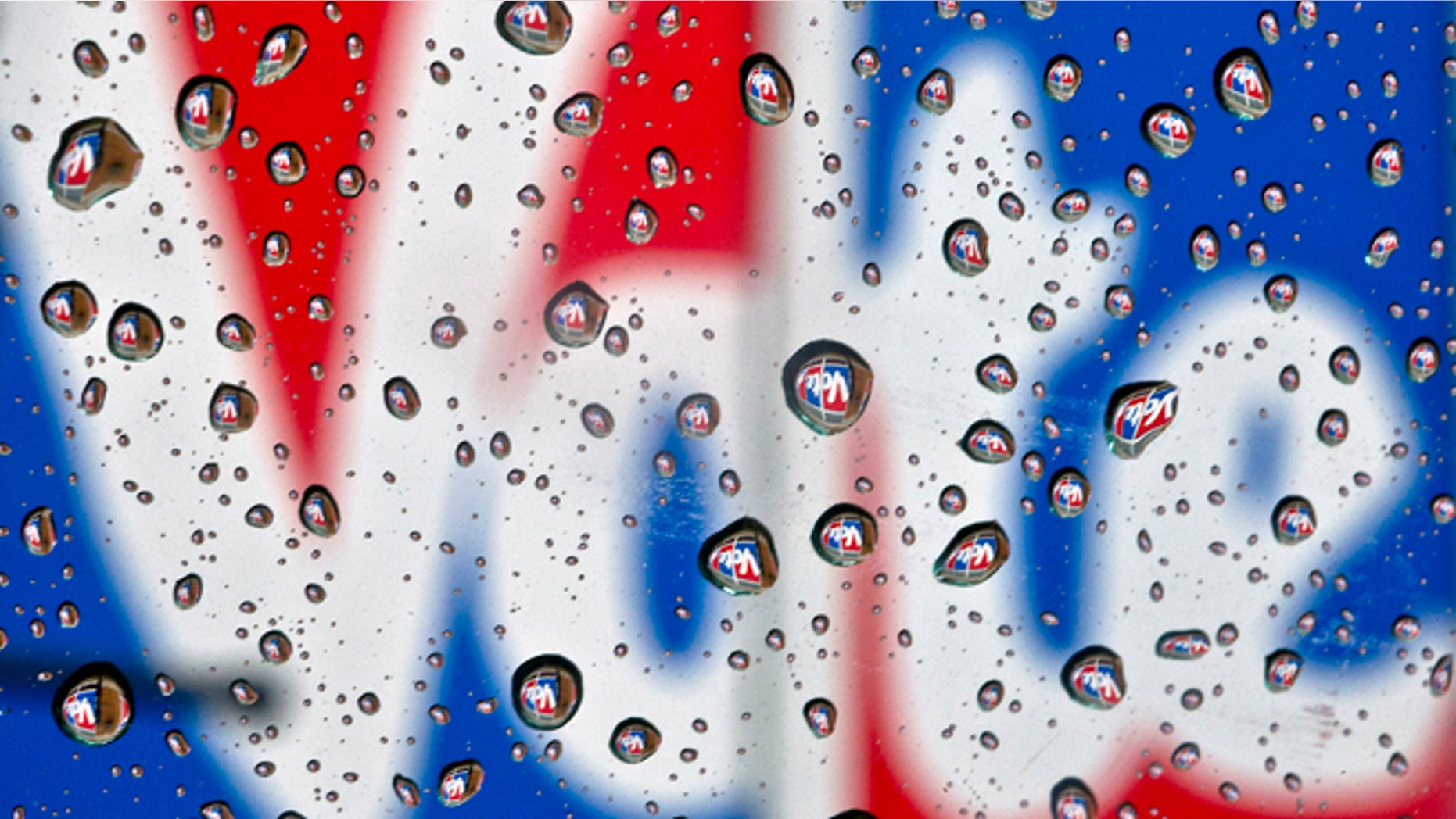 The word Vote, part of a mural to encourage voting, is reflected in raindrops in Danville, Ky., on Monday, Oct. 1, 2012. President Barack Obama and Republican challenger Mitt Romney are hunkered down Monday, practicing for their first debate to take place in Denver on Wednesday, Oct. 3. (AP Photo/The Advocate Messenger, Clay Jackson)