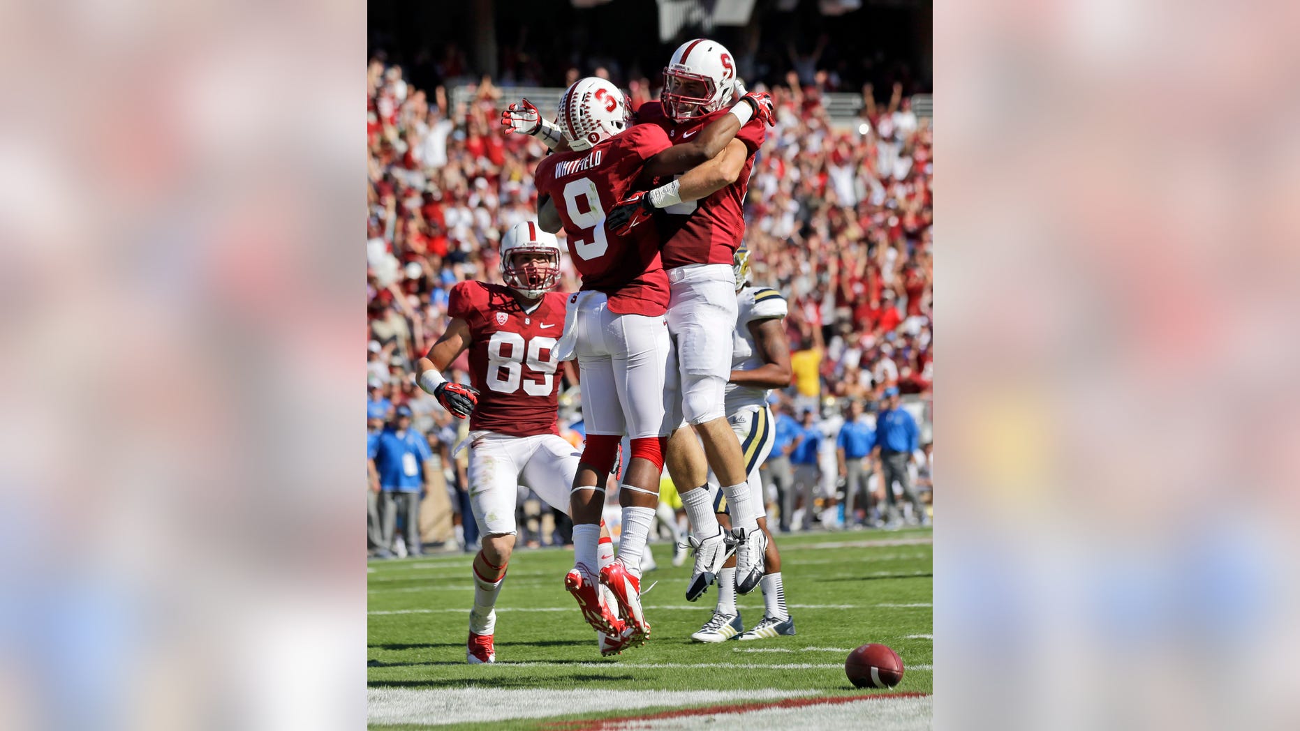 Stanford wide receiver Kodi Whitfield (9) celebrates his touchdown catch with teammate Davis Dudchock, right, during the second half of an NCAA college football game against UCLA on Saturday, Oct. 19, 2013, in Stanford, Calif. Stanford won 24-10. (AP Photo/Marcio Jose Sanchez)