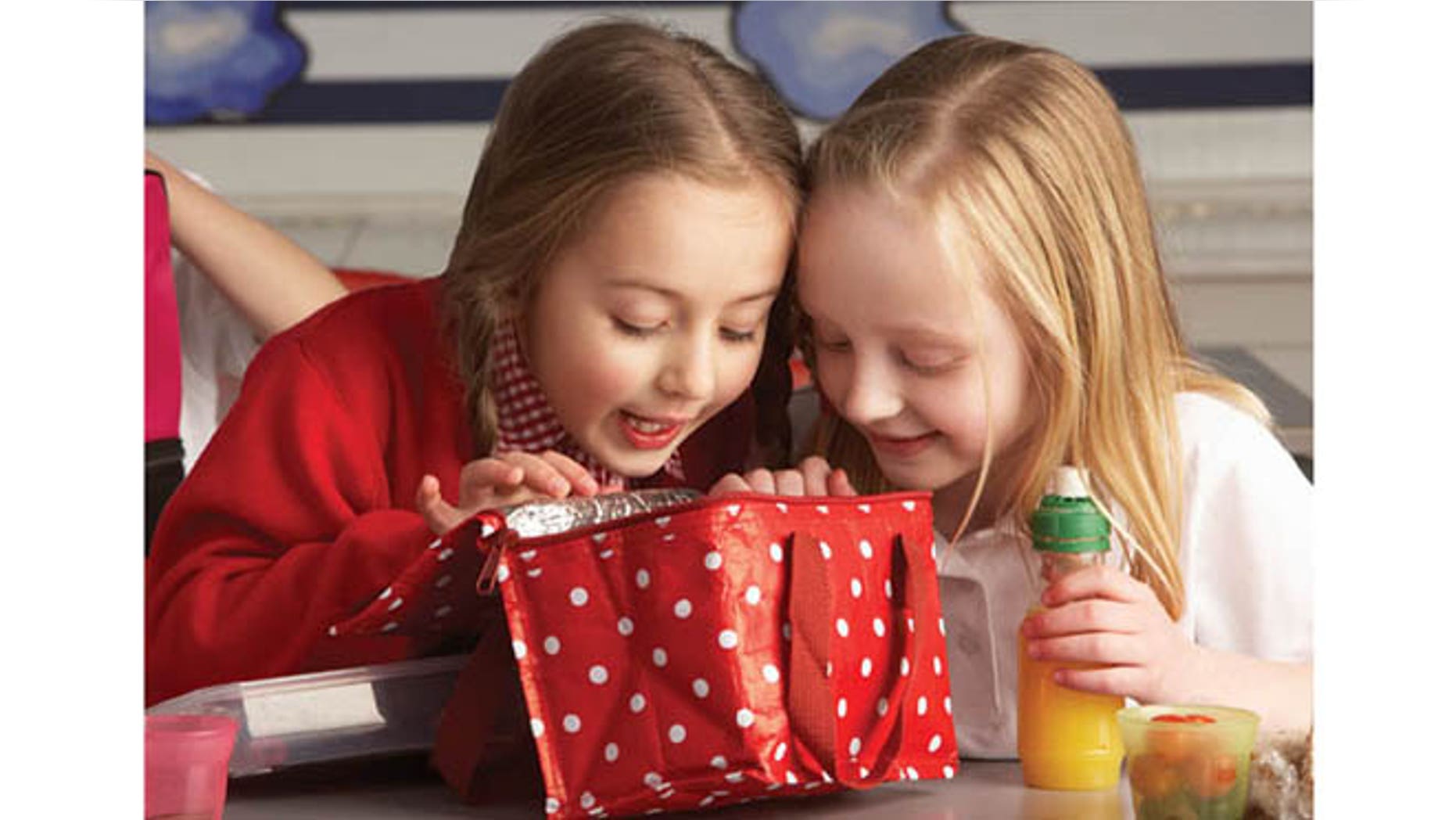 FILE -- Primary school pupils enjoying packed lunch in a classroom