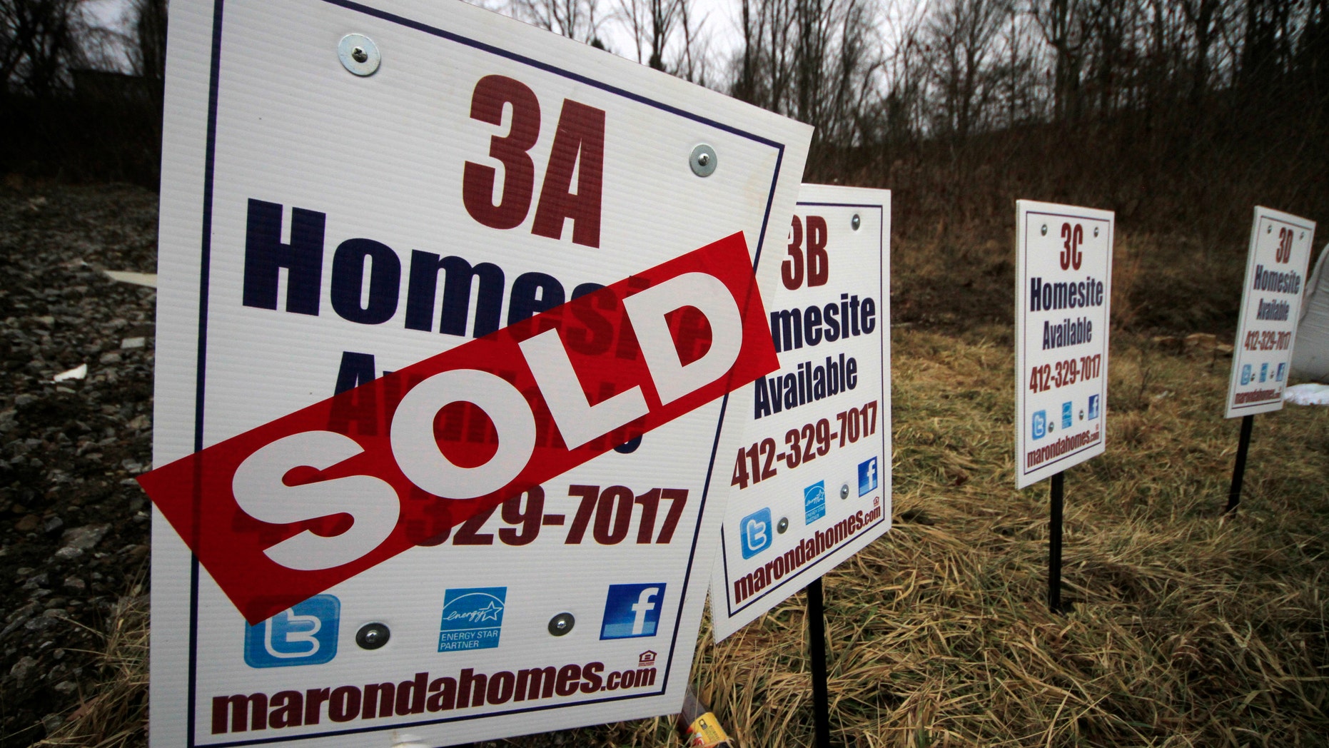 In this Monday, Jan. 13, 2014, photo, a sold sign is placed on a homesite in the Grace Manor townhouse development in Robinson Township, Pa. Freddie Mac, the mortgage company, releases weekly mortgage rates, on Thursday, Jan. 16, 2014.(AP Photo/Gene J. Puskar)