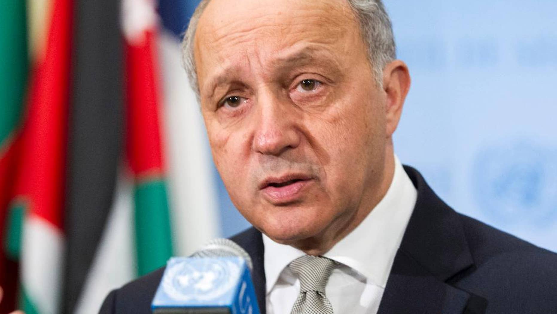 In this March 27, 2015, photo provided by the United Nations, Laurent Fabius, Minister of Foreign Affairs of France, speaks with the media at United Nations headquarters. Fabius said Friday his country will propose a U.N. Security Council resolution in the coming weeks that could present a framework for negotiations toward resolving the Israeli-Palestinian conflict. (AP Photo/United Nations, Rick Bajornas)