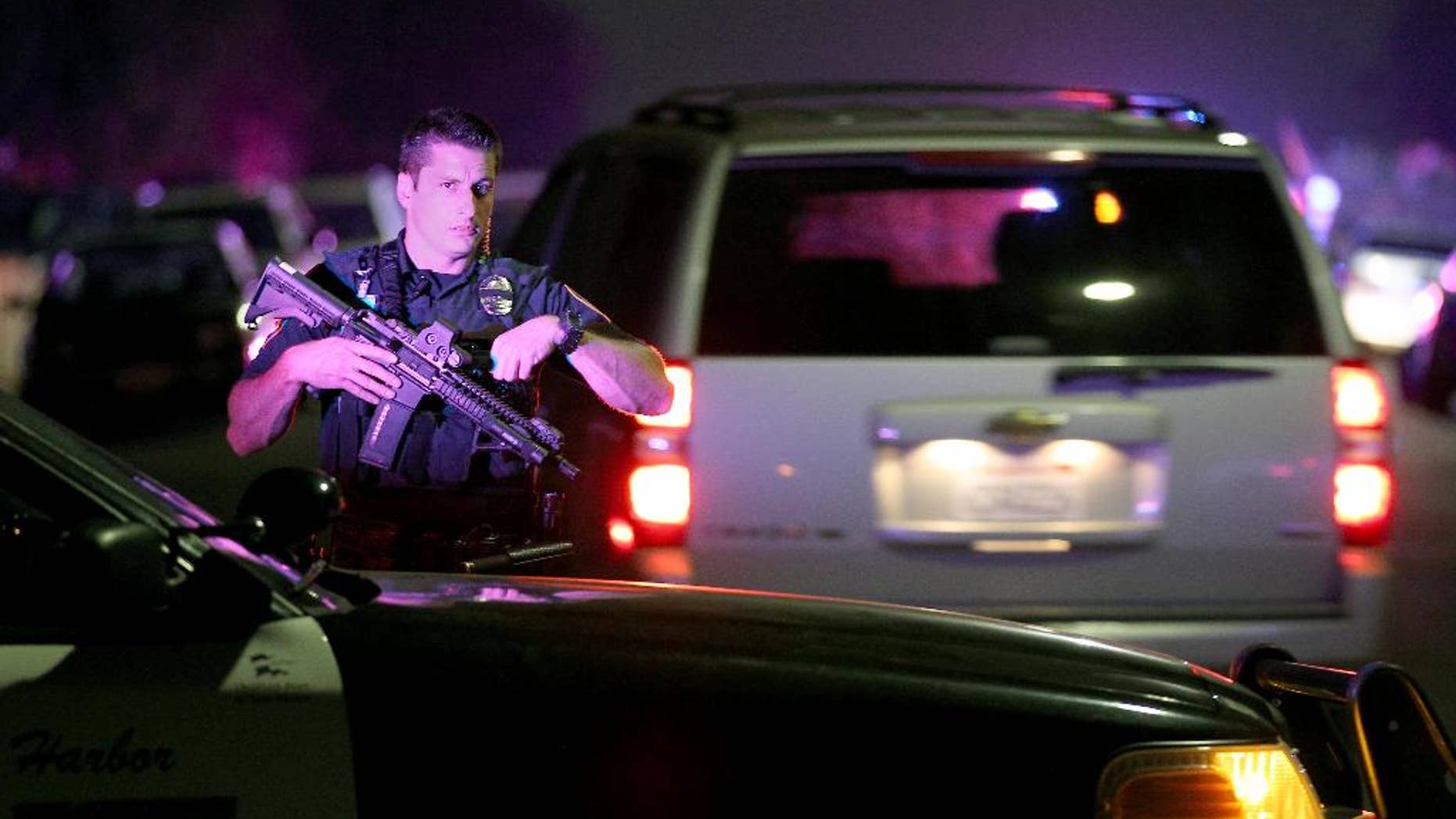 A San Diego Harbor Police officer helps to secure the scene near the corner of 39th Street and Boston Avenue in San Diego near where two San Diego Police officers were shot Thursday night, July 28, 2016. (John Gastaldo/The San Diego Union-Tribune via AP)