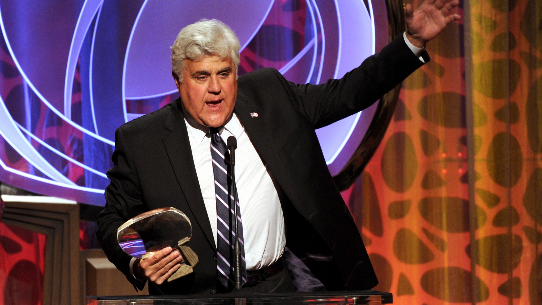 In this Tuesday, March 11, 2014 photo, Hall of Fame inductee Jay Leno speaks on stage at the 2014 Television Academy Hall of Fame at the Beverly Wilshire in Beverly Hills, Calif.